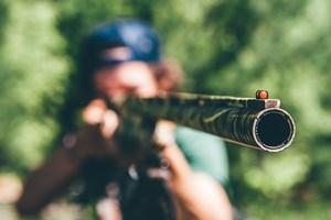 Man pointing shotgun